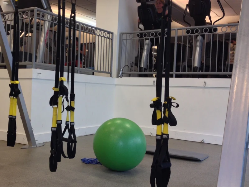 The clinic&rsquo;s training area, with suspension straps and a stability ball